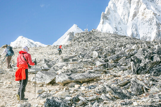 Mountaineers acclimatizing ascending a boulder field near Everest