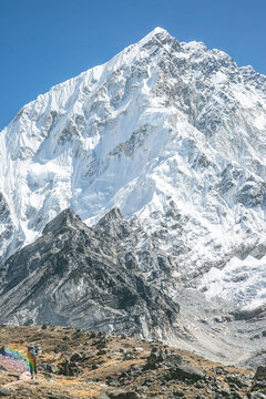 Climber on the trail in front of Nuptse's impressive South Face