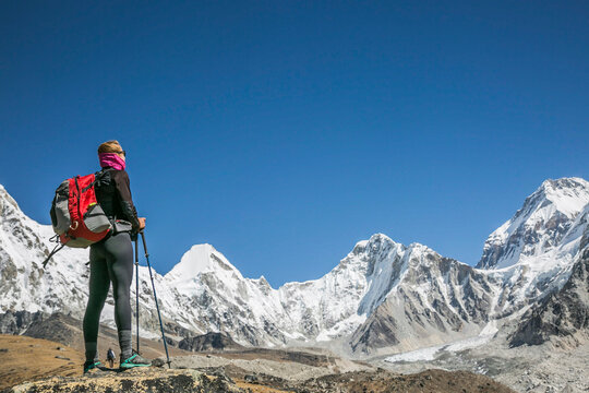A woman contemplates a cirque of peaks in the Everest Region