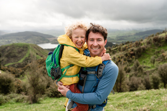 Happy father and son smiling on hike in New Zealand