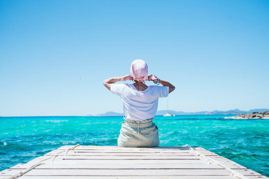 Woman with pink headscarf, has cancer