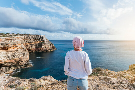 Woman with pink headscarf, has cancer