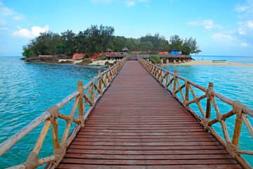 Fototapeta premium Wooden dock walkway to a small, idyllic tropical island, Zanzibar.