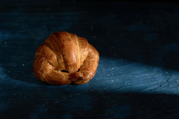 Fresh croissant on dark mood background and copy space
