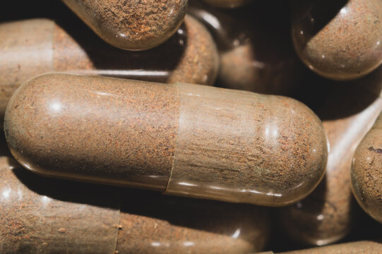 Brown capsule pills close up. herbal medicine