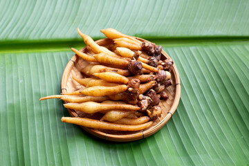 Finger root in bamboo basket on banana leaf