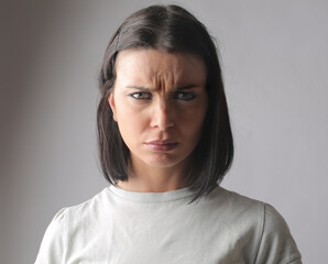 Closeup of a Hungarian brunette looking into the camera with a confused gaze and furrowed brows
