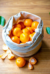A basket tangerines against wooden
 background