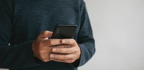 Close up hands holding smartphone. man using cellphone for searching data and social media on internet. technology concept