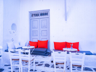 table and chairs with red cushions