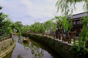 Fototapeta na wymiar [小江戸さわら舟めぐり] Willows and old townscapes along the Ono River / Sawara, Katori City, Chiba Prefecture, Japan