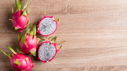 Fototapeta na wymiar Dragon fruit or pitaya on wooden background, Tropical fruit, Table top view