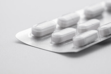 Fototapeta na wymiar Pills in foil packaging on a white background
