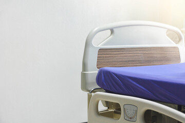 Empty modern electric hospital bed or patient's bed in hospital ward over white background, copy...