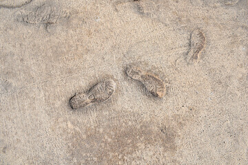 imprints of shoe soles in concrete