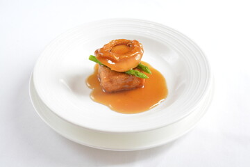 braised whole big abalone with bean curd tofu and broccoli in chef premium oyster sauce in white background asian halal seafood menu