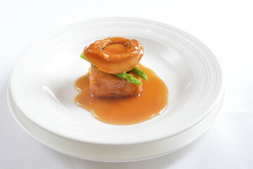braised whole big abalone with bean curd tofu and broccoli in chef premium oyster sauce in white background asian halal seafood menu
