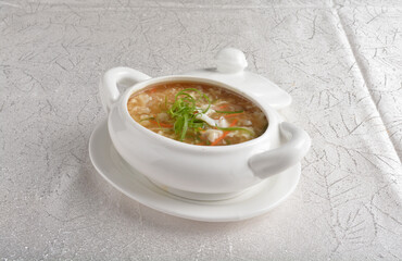 double boiled fish maw shark's fin thick hot soup in white bowl in white background asian halal seafood menu