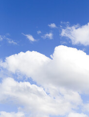Naklejka na ściany i meble Background of white summer clouds on blue sky.