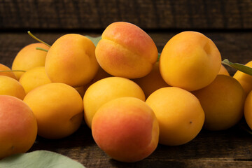 Orange-red apricots on a wooden table.Fresh, juicy and delicious apricots.