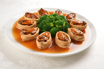 braised fresh oyster in bean curd tofu skin and broccoli with chef special oyster sauce in white background asian halal seafood menu