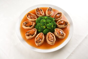 braised fresh oyster in bean curd tofu skin and broccoli with chef special oyster sauce in white background asian halal seafood menu