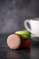 a pile of macaroons and a cup isolated on gray backgound
