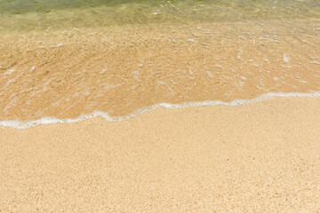 Wave of the sea on the sand beach