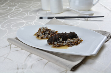 braised cook whole sea cucumber with vegetable in special chef oyster thick sauce in white background asian halal seafood menu