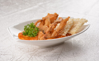 deep fried soft shell whole crab with spicy chilli crab sauce dip and crackers in white background asian halal seafood menu