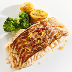 Appetizing grilled fish steak and vegetables