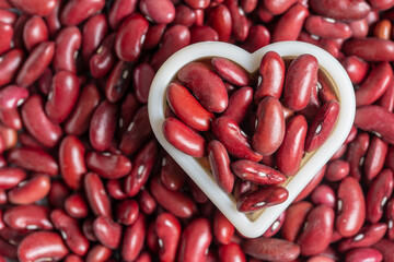 Red bean beans together with a heart shape as pattern background