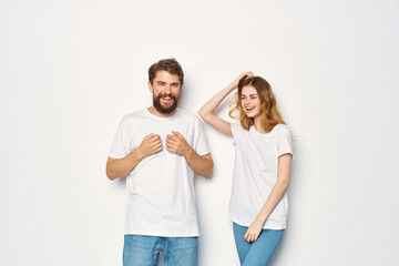 Fototapeta premium young couple in white t-shirts communication clothes jeans light background