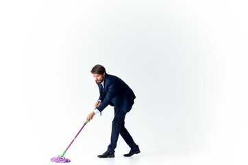 man in a suit with a mop in his hands emotions cleaning official