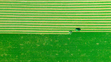 Fotobehang Aerial view of tractor as tow lawn mower machinery behind © Roman_23203