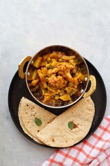 Aloo Gobi Mutter curry, cauliflower, and peas curry. Aloo Gobi masala. Served with wheat roti. famous Indian curry dish with potatoes and green peas. Copy space