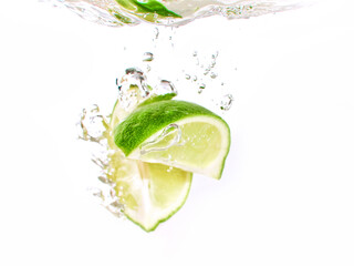 lime and lemon splashing water isolated on white background - 446909134
