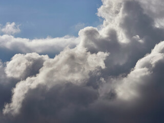 Fototapeta na wymiar Dark and white clouds on a background of blue sky