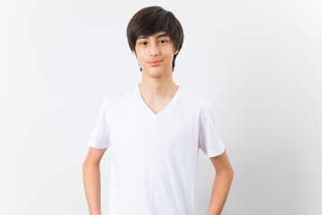 Handsome teen boy smile and standing on white background.