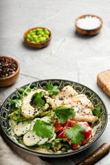 avacado salad with squid and fresh vegetables closeup with copy space