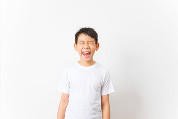 Asian boy wearing white t-shirt with funny face isolated on white background.