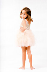 Portrait of happy pretty curly little girl standing and posing over white background