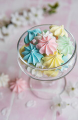 Fototapeta na wymiar Small colorful meringues in the glass