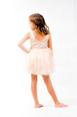 Portrait of happy pretty curly little girl standing and posing over white background