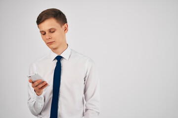 business man in a shirt with a tie with a phone in his hands communication