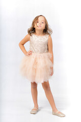 Naklejka premium Portrait of happy pretty curly little girl standing and posing over white background