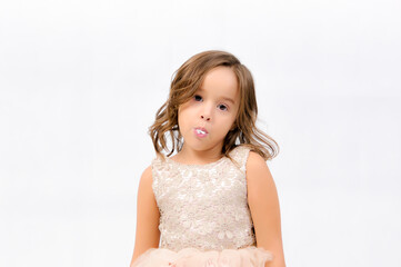 Portrait of happy pretty curly little girl standing and posing over white background