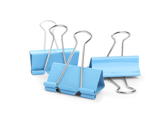 Fototapeta premium Light blue binder clips on white background. Stationery
