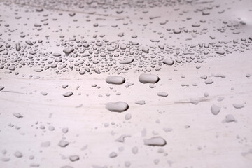 Rain drops on a shiny surface, water drops background