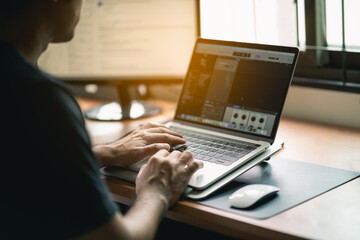 sound engineer working with laptop on the table at the home office